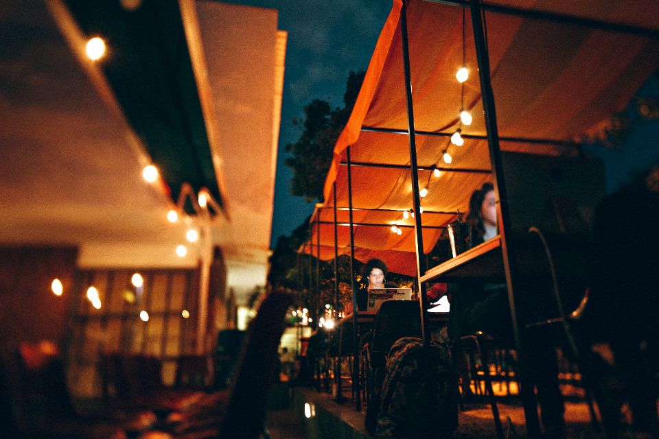 A long bar under warm string lights